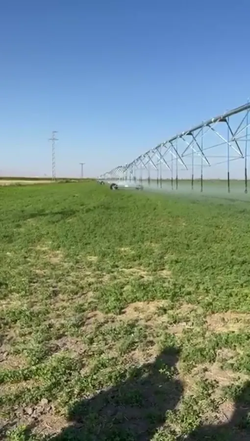 An AksuPivot machine running over dense green crop in Konya, the spans reaching to the horizon
